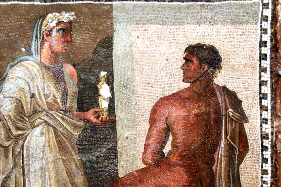 This Roman mosaic depicts Orestes and Iphigenia, with Iphigenia holding a small statue of Artemis — imagery drawn from Greek myth and popular across the Roman world. Mosaics like this often decorated the floors of bath complexes and latrines, where vibrant storytelling scenes enlivened communal spaces.