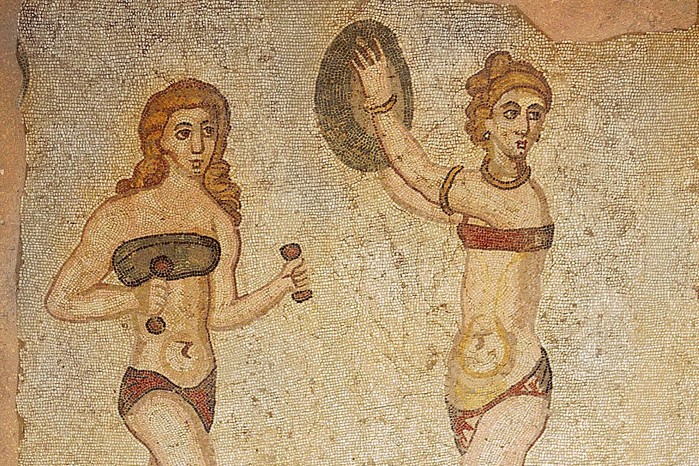This detail from the 'Ten Girls' mosaic at the Villa del Casale in Piazza Armerina shows young women training with hand weights and a discus. Dating to the early 4th century AD, the scene highlights the place of athletic exercise in elite Roman life.