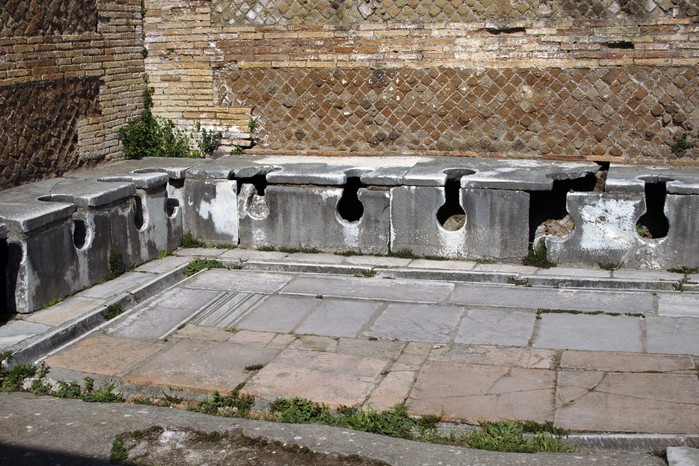 The remains of this 2nd-century AD latrine show the communal approach to Roman toilets. The site is in the Domus of the Triclinium at Ostia Antica served the guild of builders who worked in the bustling port of Rome.