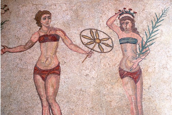 Mosaic in the Roman villa of Casale, near Piazza Armerina, Sicily, Italy, showing women exercising. (Photo by Peter Thompson/Heritage Images/Getty Images) A mosaic that shows two Roman women exercising, one holds a flower and another holds a leaf