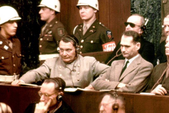 Defendants at the Nuremberg Trials listen to proceedings in 1946. In the front row sit Hermann Göring, Rudolf Hess, Joachim von Ribbentrop, Wilhelm Keitel, and Ernst Kaltenbrunner; behind them are Karl Dönitz, Erich Raeder, Baldur von Schirach, and Fritz Sauckel. Together they represent the senior leadership of the Nazi regime held to account for its crimes.