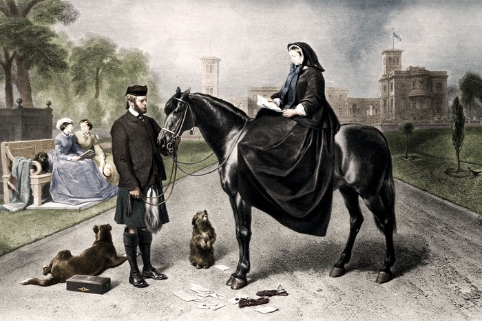 A painting of Victoria and John Brown at Osborne House, her private family home on the Isle of Wight, in 1865. Brown began accompanying the queen more frequently after Albert’s death, first joining her at Osborne in 1864 (Image by TopFoto) A painting shows Queen Victoria dressed all in black on top of a black horse. To the left, John Brown, dressed in black with a kilt, stands holding the horse's reign. By him, two dogs lay on the ground. On the far left, two women, dressed in blue and beige are seated on a bench. In the background, there is a large yellow manor house
